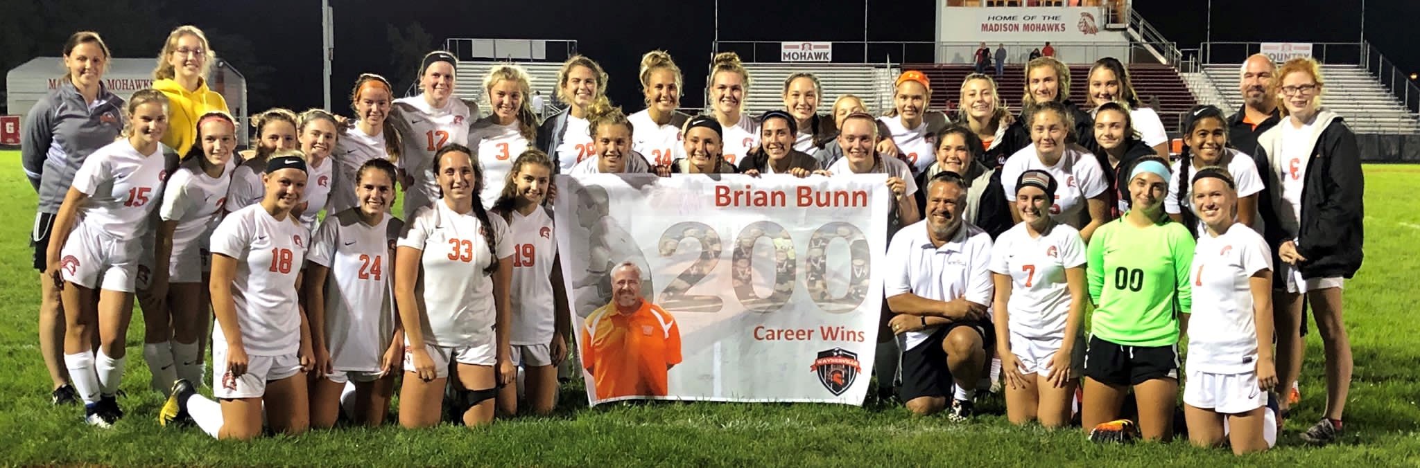 soccer team with a banner in front